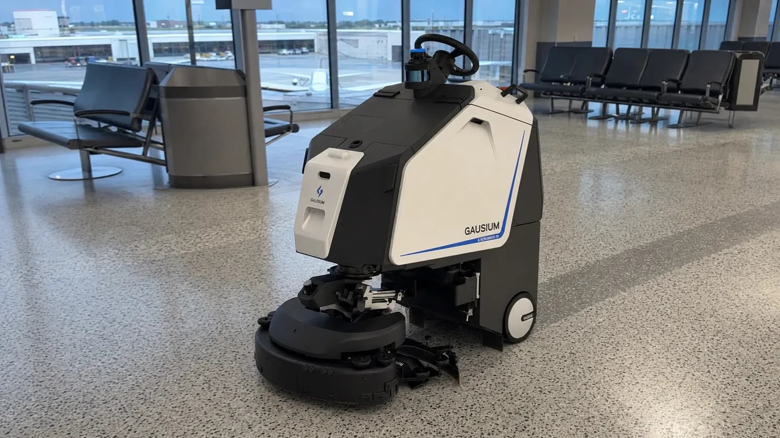 Gausium Scrubber 75 in an airport concourse