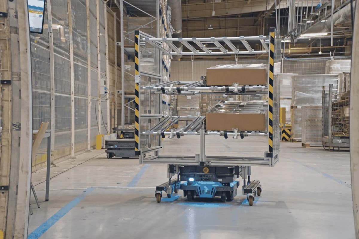An autonomous mobile robot moving material on a manufacturing plant floor